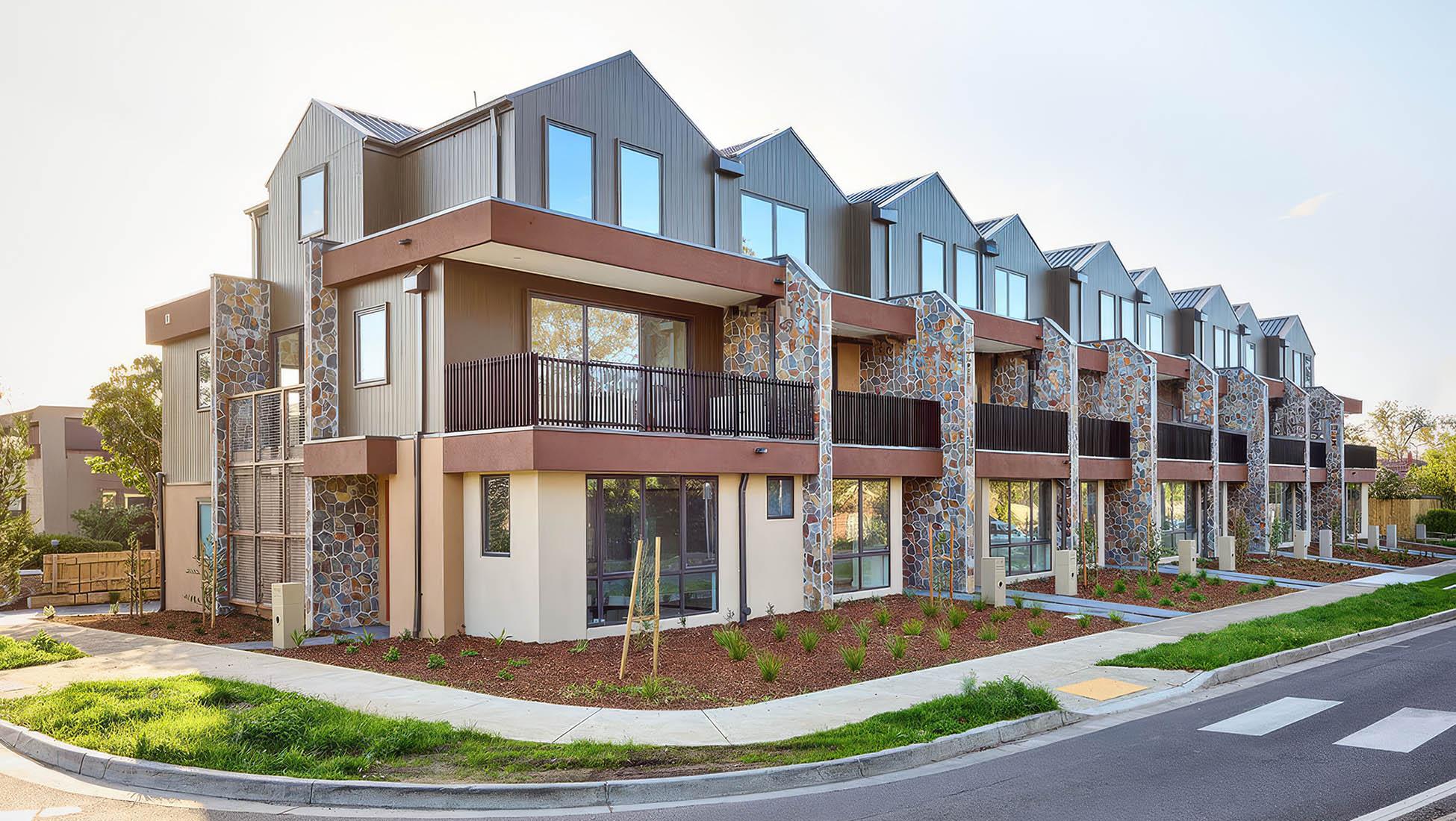 Corner frontage of nine-unit townhouse development with balconies and mixed materials in Eltham
